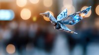 Origami paper crane in blue patterned paper flying against blurred bokeh background with warm glowing lights creating magical atmospheric mood.