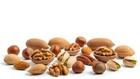 Mixed nuts collection with almonds, walnuts, hazelnuts and pistachios on white background for healthy snacking and cooking ingredients.