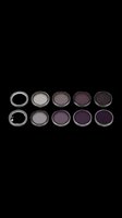 Ten camera lens filters arranged in two rows, progressing from clear to dark neutral density gradations, isolated on transparent background, ready for design use on t-shirts, stickers, and print-on-demand products.