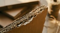 Corrugated cardboard sheets showing detailed fluted structure and layers, sustainable packaging material for shipping and storage solutions.