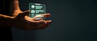 Hand holding glowing digital interface with business icons showing workflow automation and smart technology solutions for modern enterprises.