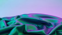 Flowing iridescent fabric with holographic rainbow colors creating dynamic waves and folds against gradient background for modern design projects.
