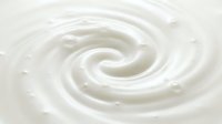Creamy white swirl texture with smooth spiral motion, suitable for cosmetics, dairy, skincare, and food product backgrounds.