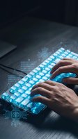 Hands typing on futuristic glowing blue keyboard with digital circuit patterns and binary code overlays for technology and cybersecurity concepts.