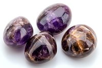 Polished amethyst and smoky quartz palm stones with natural crystal formations and patterns displayed on white background, showing mineral variations and healing properties.