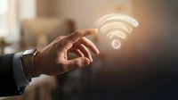 Businessman hand touching glowing wifi symbol for wireless internet connection and digital network technology concept.