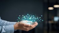 Male professional in light blue shirt holding glowing digital network data visualization with connected nodes and particles, representing technology, connectivity, innovation, and business solutions.