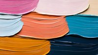 Colorful layered paper sheets creating abstract waves and curves in pink, orange, blue, and yellow tones. Modern minimalist composition with textured edges.