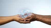 Young and elderly hands connecting with glowing digital network symbol representing intergenerational technology transfer and communication.