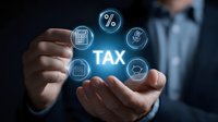 Businessman holding glowing tax concept with financial icons floating between hands, representing taxation, accounting, and financial planning services.