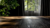 Wooden table surface with natural sunlight streaming through window and green plants creating dramatic shadows, suitable for product photography background.