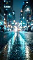 Blurred city street at night with wet asphalt reflecting colorful lights and bokeh effects creating atmospheric urban scene for backgrounds and design projects.