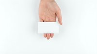 Adult male hand holding blank white card on isolated background, ready for custom text or branding design.