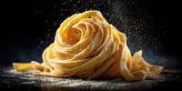 Fresh homemade pasta nest with flour dust against dark background, dramatic food photography highlighting Italian cuisine texture and craftsmanship.