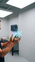 Middle-aged Caucasian businessman holding holographic data visualization in modern office environment showcasing digital transformation and futuristic technology.