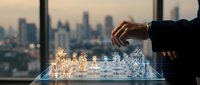 Business strategy concept with professional playing holographic chess game against city skyline backdrop during golden hour sunset.