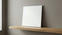 Blank white canvas on wooden shelf against gray wall ready for artwork display in modern minimalist interior space for creative projects and home decor.