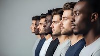 Diverse group of young professional men standing in profile line showing teamwork unity and collaboration in modern workplace environment.