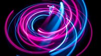 Glowing neon swirls in magenta and cyan create dynamic spiral motion against black background, suitable for tech, music, and digital design projects.