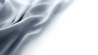 Elegant silver silk fabric with flowing waves and soft shadows creating luxurious textile background for fashion and interior design projects.