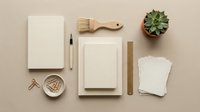 Minimalist beige stationery flat lay with notebooks, wooden brush, succulent plant and office supplies arranged on neutral background for branding mockup.