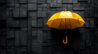Yellow umbrella floating against dark geometric wall background creates dramatic contrast and minimalist composition for business and protection concepts.
