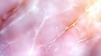 Soft pink marble texture with delicate white veining creates elegant natural pattern for luxury surface design and premium backgrounds.