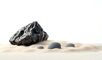 Minimalist zen composition with dark volcanic rock and smooth gray pebbles arranged on fine sand against white background, creating peaceful balance and harmony.