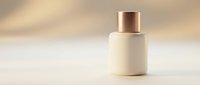 Elegant cream cosmetic bottle with gold cap on a soft beige background, perfect for luxury skincare and beauty product branding mockups.