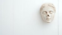 Classical plaster sculpture face with closed eyes on white background, isolated wall art decor element for interior design and artistic projects.