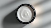 Luxurious white face cream in black container with soft shadow overlay, showcasing premium skincare product for beauty and cosmetic industry.