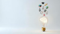Glowing light bulb with educational icons floating above representing knowledge, learning and academic achievement on clean background.