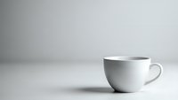 White ceramic coffee cup on clean minimalist surface with soft shadow and neutral background for modern kitchen and cafe branding concepts.