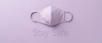 Lavender fabric face mask on matching purple background with Stay Safe text, flat lay composition for health and safety awareness.