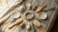 Natural spa wellness setup with wooden brushes, ceramic bowls, massage tools and eucalyptus on knitted textile background for relaxation and self-care rituals.