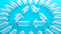 Plastic water bottles arranged in circle on bright turquoise background, overhead view. Recycling, sustainability, environmental awareness, waste management concept for eco-friendly campaigns.