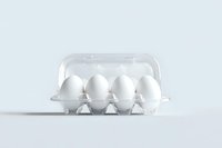 Fresh white eggs in transparent plastic container on light background, minimalist food composition for healthy eating and cooking concepts.