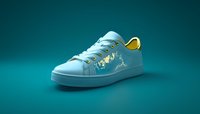 White sneaker with gold floral embroidery pattern on turquoise background. Modern casual footwear design features decorative side stitching and yellow heel accent.
