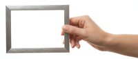 Hand holding empty gray wooden picture frame on white background isolated for design mockup presentation display artwork photography.