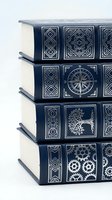 Stack of elegant navy blue hardcover books with silver embossed spines featuring compass, tree, and gear motifs on white background.