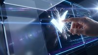 Young male hand touching glowing digital interface with sparkling light effects and holographic data visualization, representing technology innovation and futuristic interaction.
