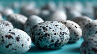 Speckled bird eggs with natural spotted patterns scattered on turquoise surface creating organic texture for nature and wildlife themed designs.
