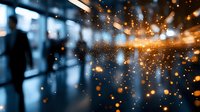 Glowing orange sparks and bokeh lights create magical atmosphere against blurred dark blue background, abstract festive backdrop for holiday designs.