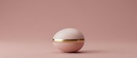 Elegant pink sphere with golden band on matching background for luxury cosmetics packaging and premium product design concepts.