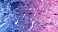 Abstract fluid art background with pink and blue paint mixing creates dynamic marble texture with swirling patterns and organic flowing shapes.
