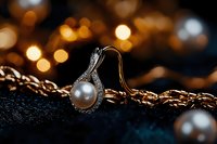 Elegant pearl ring with diamond accents on gold chain against dark background with soft bokeh lights creating luxurious jewelry composition.