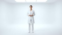 Young female healthcare professional with South Asian ethnicity wearing white medical coat and pants, standing confidently in studio setting for medical, hospital, and clinical use.