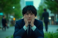 Young Asian businessman with shocked expression holding face in hands on urban street, portraying stress, anxiety, and workplace pressure.