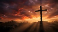 Wooden cross silhouetted against dramatic sunset sky with golden sunbeams breaking through clouds on hilltop for Easter and Christian faith concepts.