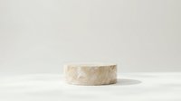 Minimalist marble podium display stand on neutral beige background for product presentation and branding showcase in modern studio setting.